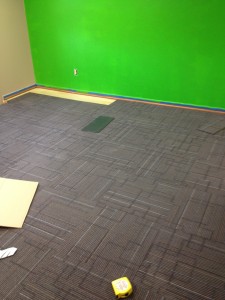 Carpet being installed in large conference room